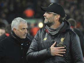 Liverpool manager Juergen Klopp, right, and Manchester United manager Jose Mourinho seen prior to the English Premier League soccer match between Liverpool and Manchester United at Anfield in Liverpool, England, Sunday, Dec. 16, 2018.
