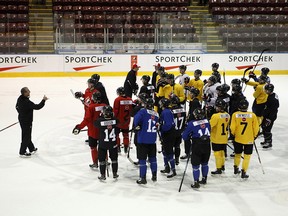 Team Canada head coach Tim Hunter talks with players during selection camp at the Q Centre in Victoria, B.C., on Tuesday, December 11, 2018. (THE CANADIAN PRESS/Chad Hipolito)