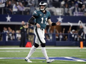 Eagles quarterback Carson Wentz walks off the field after he fumbled the ball and the Cowboys recovered during first half NFL action, in Arlington, Texas, Sunday, Dec. 9, 2018.