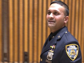 New York City police officer Syed Ali walks out of a briefing room at police headquarters, Thursday, Dec. 27, 2018. (AP Photo/Michael R. Sisak)