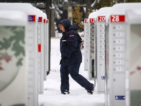 Canada Post employee Shelly Paul delivers the mail in snowy Water Valley, Alta., Tuesday, Oct. 2, 2018.
