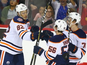 Oilers celebrate a goal by Caleb Jones (L) during an NHL pre-season rookie game between the Edmonton Oilers and Calgary Flames in Calgary on Sunday, September 9, 2018. Jim Wells/Postmedia