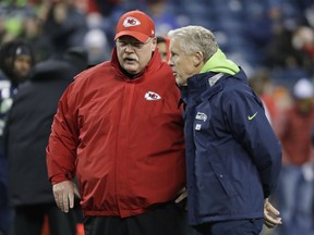 Seattle Seahawks head coach Pete Carroll, right, talks with Kansas City Chiefs head coach Andy Reid, left, before an NFL game, Sunday, Dec. 23, 2018, in Seattle.