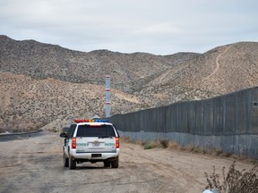 FILE - In this Jan. 4, 2016, file photo, a U.S. Border Patrol agent patrols Sunland Park along the U.S.-Mexico border next to Ciudad Juarez. A 7-year-old girl who had crossed the U.S.-Mexico border with her father, died after being taken into the custody of the U.S. Border Patrol, federal immigration authorities confirmed Thursday, Dec. 13.