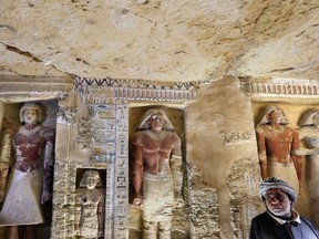 Saeed Abdel Aal, an excavation worker stands at the recently uncovered tomb of the Priest royal Purification during the reign of King Nefer Ir-Ka-Re, named "Wahtye", at the site of the step pyramid of Saqqara, in Giza, Egypt, Saturday, Dec. 15, 2018.