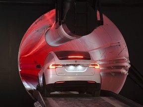 A modified Tesla Model X drives in the tunnel entrance before an unveiling event for the Boring Co. Hawthorne test tunnel in Hawthorne, Calif., Tuesday, Dec. 18, 2018. Elon Musk unveiled his underground transportation tunnel on Tuesday, allowing reporters and invited guests to take some of the first rides in the revolutionary albeit bumpy subterranean tube - the tech entrepreneur's answer to what he calls "soul-destroying traffic."