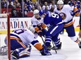 Toronto Maple Leafs centre John Tavares (91) battles for the puck in front of New York Islanders goaltender Robin Lehner (40) as Islanders defenceman Ryan Pulock (6) and defenceman Scott Mayfield (24) defend during first period NHL hockey action in Toronto, Dec. 29, 2018. (THE CANADIAN PRESS/Frank Gunn)