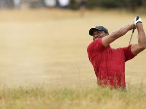 In this July 22, 2018, file photo, Tiger Woods of the U.S. plays out of a bunker on the 10th hole during the final round for the 147th British Open Golf championships in Carnoustie, Scotland.