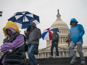 Tourists arrive to visit the U.S. Capitol on a rainy morning in Washington, Friday, Dec. 28, 2018, during a partial government shutdown. The partial government shutdown will almost certainly be handed off to a divided government to solve in the new year, as both parties traded blame Friday and President Donald Trump sought to raise the stakes in the weeklong impasse.