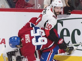 Montreal Canadiens right wing Andrew Shaw collides with Ottawa Senators left wing Tom Pyatt during first period NHL hockey action in Montreal, Saturday.