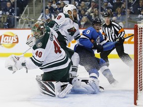 Minnesota Wild's goaltender Devan Dubnyk stops a shot from Winnipeg Jets' Andrew Copp (9) as Jordan Greenway (18) defends during second period NHL action in Winnipeg on Saturday, December 29, 2018. THE CANADIAN PRESS/John Woods