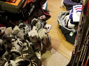 Donated hockey equipment is shown in Vancouver high school hockey coach Todd Hickling's basement in a handout photo. (THE CANADIAN PRESS/HO-Todd Hickling)