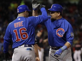 Chicago Cubs' Kyle Schwarber is congratulated by first base coach Brandon Hyde during Game 2 of the World Series against the Cleveland Indians Wednesday, Oct. 26, 2016, in Cleveland. (AP Photo/David J. Phillip)