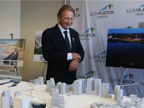 Eugene Melnyk walks in front of his winning proposal of the Lebreton Flats redevelopment in Ottawa, April 28, 2016.