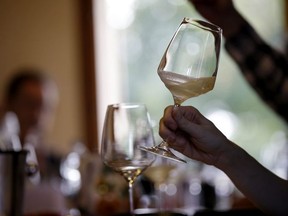 In this image taken on Monday, Oct. 15, 2018, an expert wine tester shakes a glass of Prosecco during a wine testing at the Case Paolin farm, in Volpago del Montello, Italy. Prosecco has become the best-selling sparkling wine in the world, and experts say it is eroding the more casual corner of champagne's market while aiming higher. Its production eclipsed champagne's five years ago and is now 75 percent higher at 544,000 bottles three-quarters of which for export.0 bottles three-quarters of which for export.(AP Photo/Luca Bruno) ORG XMIT: XLB109