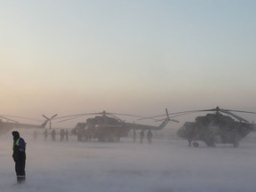 Search and rescue helicopters are seen before a flight to the landing area of the Soyuz MS-09 capsule with the International Space Station (ISS) crew onboard during sunrise in the town of Zhezkazgan, formerly known as Dzhezkazgan, Kazakhstan, Thursday, Dec. 20, 2018.