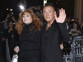 FILE - In this Oct. 12, 2017 file photo, musician Bruce Springsteen and his wife Patti Scialfa exit the stage door after the "Springsteen On Broadway" opening night performance at the Walter Kerr Theatre in New York. Director Thom Zimny's "Springsteen on Broadway" film will appear on Netflix early in the morning of Dec. 16, hours after the singer's 236th and last performance.
