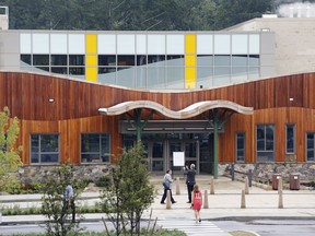 In this July 29, 2016 file photo, people attend an open house at the new Sandy Hook Elementary School in Newtown, Conn., built to replace the one that was demolished where 20 first graders and six educators were shot and killed in on Dec. 14, 2012.