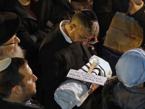 Relatives of Israeli couple Amichai and Shira Ish-Ran attend the funeral of their baby, who died after being delivered prematurely due to Shira being wounded in a drive-by shooting attack by a Palestinian man, at the Jewish cemetery on the Mount of Olives in front of Jerusalem's Old City, on Dec. 12, 2018.