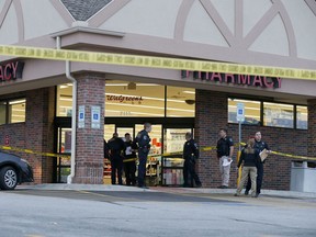 In this Dec. 19, 2018, file photo, police work at the scene of a shooting at a Walgreens in Tulsa, Okla.