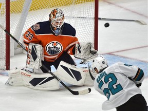 Edmonton Oilers goalie Cam Talbot (33) had to use a teammates stick after losing his behind the net, on a shot from San Jose Sharks Lukas Radil (52) during NHL action at Rogers Place in Edmonton, December 29, 2018.