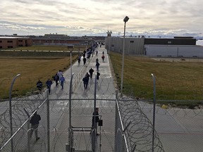 In this Jan. 30, 2018 file photo, inmates walk across the grounds of the Idaho State Correctional Institution in Kuna, Idaho. (AP Photo/Rebecca Boone, File)