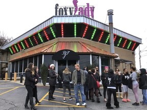 Former workers gather outside the Foxy Lady strip club, Thursday, Dec. 20, 2018, in Providence, R.I. The city ordered the club to close on Wednesday. A city board voted to revoke its licenses after police charged three dancers with prostitution the previous week.