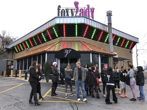 Former workers gather outside the Foxy Lady strip club, Thursday, Dec. 20, 2018, in Providence, R.I. The city ordered the club to close on Wednesday. A city board voted to revoke its licenses after police charged three dancers with prostitution the previous week.