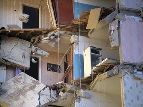 The scene of a part of a collapsed apartment building in Magnitogorsk, a city of 400,000 people, about 1,400 kilometers (870 miles) southeast of Moscow, Russia, Monday, Dec. 31, 2018. At least four people died Monday when sections of an apartment building collapsed after an apparent gas explosion in Russia's Ural Mountains region, officials said.