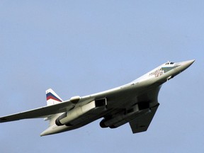 In this Tuesday, Aug. 16, 2005 file photo, a supersonic Tu-160 strategic bomber with Russian President Vladimir Putin aboard flies above an airfield near the northern city of Murmansk.