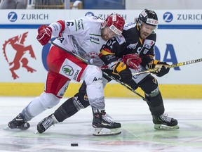 Ocelari Trinec's David Musil, left, battles against Kalevan Pallo's Ryan Wilson during the Spengler Cup in Davos, Switzerland, Thursday, Dec. 27, 2018. (Melanie Duchene/Keystone via AP)