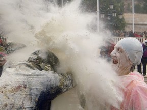 A reveller takes part in the festival of Els Enfarinats, in the town of Ibi near Alicante, Spain, Friday, Dec. 28, 2018.  For about 200-years the inhabitants of Ibi annually celebrate with a battle using flour, eggs and firecrackers, outside the city town hall.