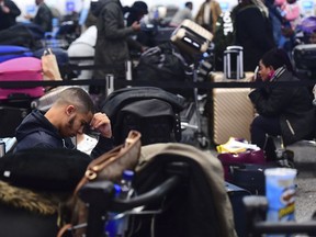 Passengers stranded at Gatwick airport, as the airport remains closed after drones were spotted over the airfield last night and this morning, in Gatwick, England, Thursday, Dec. 20, 2018.