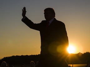 In this Nov. 26, 2018, file photo, President Donald Trump waves as he arrives to speak during a rally for Sen. Cindy Hyde-Smith, R-Miss., at Tupelo Regional Airport, in Tupelo, Miss. (AP Photo/Alex Brandon, file)