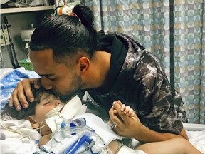In this recent undated photo, released Monday, Dec. 17, 2018, by the Council on American-Islamic Relations in Sacramento, Calif., Ali Hassan kissing his dying 2-year-old son Abdullah in a Sacramento hospital.