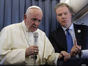FILE - In this Sunday, Aug. 26, 2018 file photo, Pope Francis, flanked by Vatican spokesperson Greg Burke, listens to a journalist's question during a press conference aboard of the flight to Rome at the end of his two-day visit to Ireland. The Vatican spokesman, Greg Burke, and his deputy resigned suddenly Monday, Dec. 31, 2018 amid an overhaul of the Vatican's communications operations that coincides with a troubled period in Pope Francis' papacy. In a tweet, Burke said he and his deputy, Paloma Garcia Ovejero, had resigned effective Jan. 1.