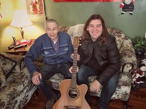 Edward Sheppard and Alan Doyle of the band Great Big Sea pose with Sheppard's new guitar, which Doyle replaced after Sheppard's guitar went missing, in a handout photo.