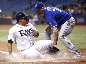 Wilson Ramos of the Tampa Bay Rays slides home safely ahead of the tag by pitcher John Axford of the Toronto Blue Jays on June 11, 2018 at Tropicana Field in St. Petersburg. (Brian Blanco/Getty Images)