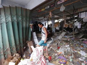 A man cleans the debris at his shop following the tsunami in Sumur, Indonesia, Tuesday, Dec. 25, 2018. The Christmas holiday was somber with prayers for tsunami victims in the Indonesian region hit by waves that struck without warning Saturday night.