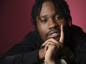 In this Nov. 30, 2018 photo, Shameik Moore, a cast member in "Spider-man: Into the Spider-Verse," poses for a portrait at the Four Seasons Hotel in Los Angeles. (Chris Pizzello/Invision/AP)