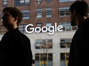 In this Dec. 4, 2017 file photo, people walk by Google offices in New York. (AP Photo/Mark Lennihan, File)