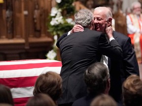 Former U.S. President George W. Bush embraces former U.S. secretary of state James Baker after he gave a eulogy during the funeral for former President George H.W. Bush at St. Martin's Episcopal Church, on Dec. 6, 2018, in Houston.