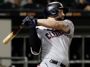 In this Sept. 25, 2018, file photo, Cleveland Indians' Yonder Alonso hits a two-run single against the Chicago White Sox during the third inning of a baseball game in Chicago.