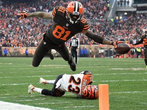 Rashard Higgins of the Cleveland Browns dives for a touchdown in front of Darius Phillips of the Cincinnati Bengals during the third quarter at FirstEnergy Stadium on Dec. 23, 2018 in Cleveland, Ohio.