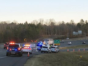 Emergency vehicles are parked along Interstate 30 near the scene where a charter bus that was carrying a youth football team from Tennessee crashed early Monday, Dec. 3, 2018, near Benton, Ark. (Josh Snyder/The Arkansas Democrat-Gazette via AP)