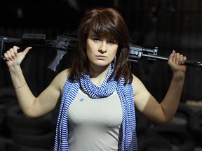 In this photo taken on Sunday, April 22, 2012, Maria Butina, a gun-rights activist, poses for a photo at a shooting range in Moscow, Russia.