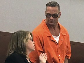 In this Aug. 17, 2017, file photo, Nevada death row inmate Scott Dozier, right, confers with Lori Teicher, a federal public defender involved in his case, during an appearance in Clark County District Court in Las Vegas. (AP Photo/Ken Ritter, File)