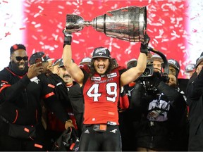 Calgary Stampeders linebacker Alex Singleton holds the Grey Cup after the team defeated the Ottawa Redblacks at Commonwealth Stadium in Edmonton on Sunday November 25, 2018. Gavin Young/Postmedia