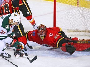 Calgary Flames goaltender Mike Smith stops this Minnesota Wild scoring chance with the Wild's Eric Fehr during NHL action at the Scotiabank Saddledome in Calgary on Thursday December 6, 2018.