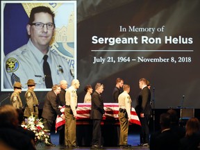 In this Nov. 15, 2018 file photo the flag draped casket of Ventura County Sheriff Sgt. Ron Helus arrives on stage for a memorial service for Helus at Calvary Community Church in Westlake Village, Calif.